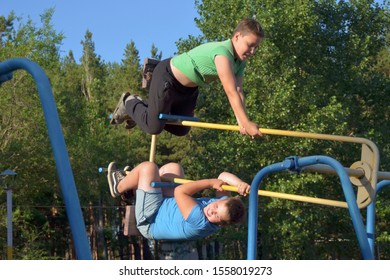 VORONEZH REGION / RF - JUNE 2019: Free Evening Time At The Russian Summer Camp. Brothers Swing Highly So It Makes Them Very Happy.