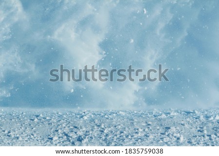 Vortex of snow during a blizzard in the region of the far North. The theme of natural disasters and the harsh polar climate. Background, image for the weather forecast.