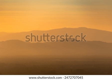 vosges mountans at sunrise with mist and sulight and clouds a dreamy mood in northern france, alsace wine region