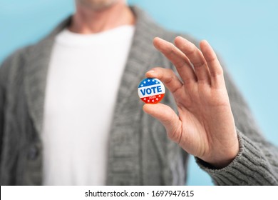 Vote 2020 In America, US. Law Abiding American Citizen Holding Vote Pin In Hand, Blurred Background