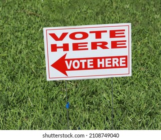 VOTE HERE SIGN Placed On The Grass At A Neighborhood Polling Place, As Seen On Election Day In Fort Lauderdale, Florida.