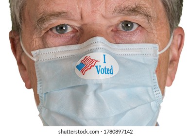 I Voted Sticker On Senior Caucasian Man's Face Mask As He Stares For The Presidential Election In The USA. Isolated During Coronavirus Pandemic