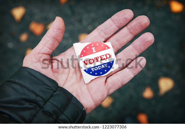 I\
voted today sticker in a persons hand after\
voting