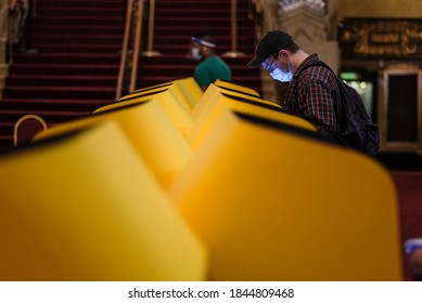 A voter casts his ballot in a vote center at at the Pantages Theatre in Los Angeles, Saturday Oct. 31, 2020.
