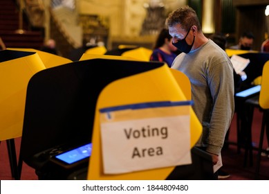 A voter casts his ballot in a vote center at at the Pantages Theatre in Los Angeles, Saturday Oct. 31, 2020.