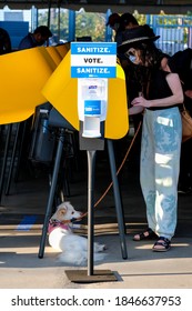 A Voter With Her Dog Casts Her Ballot At A Vote Center In Dodgers Stadium During The Election Day In Los Angeles, Tuesday, Nov. 3, 2020.