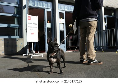 A Voter With Her Dog Waits To Cast Her Ballot For The First Round Of France's Presidential Election At A Polling Station In Lille,  France, On April 10, 2022.