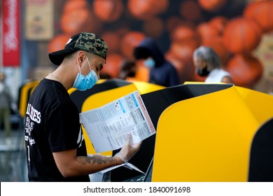 A Voter Wearing A Face Mask Casts His Ballot In A Vote Center At Staples Center In Los Angeles, Saturday Oct. 24, 2020.