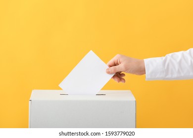 Voting Woman Near Ballot Box On Color Background