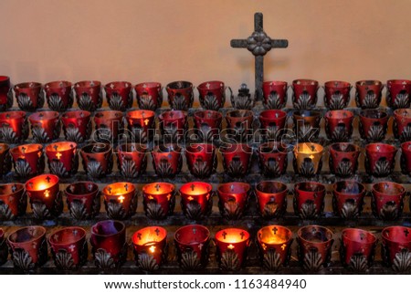 Votive candles and crucifix
