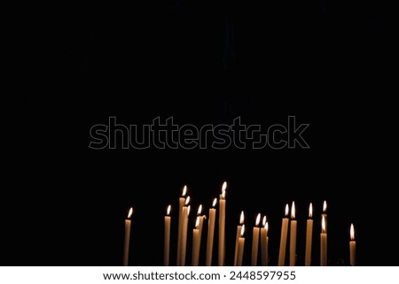 Many lighted candles in a church