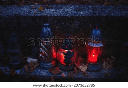 Votive candles lantern burning on the graves in Slovak cemetery at night time. All Saints' Day. Solemnity of All Saints. Hallows eve. 1st November. Feast of Saints. Hallowmas. Souls' Day in Slovakia