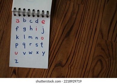 vowels in red, consonants in blue: the alphabet in handwriting - Shutterstock ID 2218929719