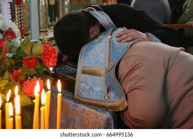 VOYUTYN, UKRAINE - 14 October 2008: Priest Covered Robe Head Of Woman During Confession In Church