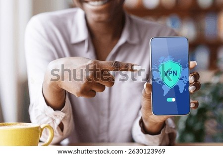 VPN App. Black Woman Pointing At Smartphone With Virtual Private Network Application