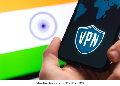 VPN In India. Secure And Safe Internet Concept. Privacy. Hand With Mobile Phone And VPN Application. Flag And Laptop On The Background Photo