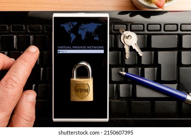 VPN (virtual private network) concept, man using a vpn software on a smartphone - Shutterstock ID 2150607395