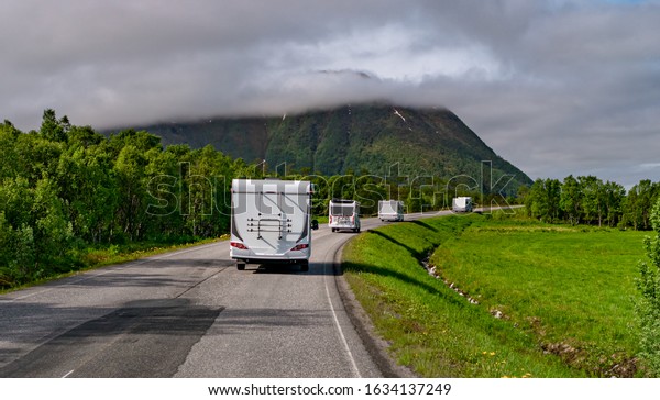 VR Caravan car\
travels on the highway. Tourism vacation and traveling. Beautiful\
Nature Norway natural\
landscape.