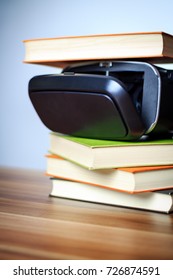 VR glasses and books on a table symbolizing digital learning.