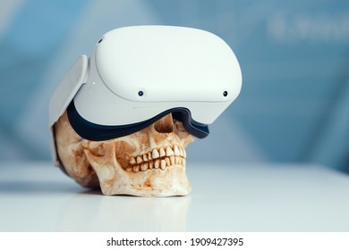 VR helmet put on a human skull the harm of virtual reality to human health.