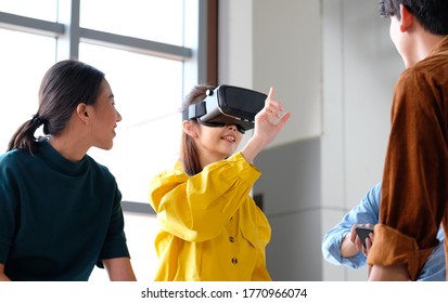 VR Mobile Phone Application Test, Asian Woman With Virtual Reality Glasses Headset In VR Experience, Asia Business Team Developers For Reality Simulator Smartphone App Test At Creative Office