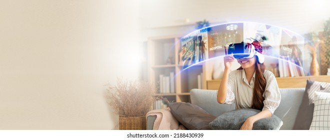 VR technology and entertainment at home concept.Young Asian Women Using Virtual Reality Headset(VR) for Online entertainment and choice movie in multimedia streaming application on Internet broadband - Shutterstock ID 2188430939