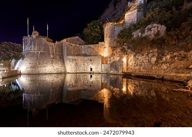 Vrata od Gurdicа (Gurdic Gate, South Gate) of famous historical medieval Kotor Stari Grad in the evening with reflections on pond, Kotor, Montenegro - Powered by Shutterstock