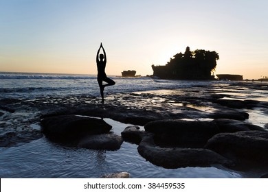 Vrikshasana Tree Pose From Yoga By Woman Silhouette On Sunset Near Tanah Lot Temple