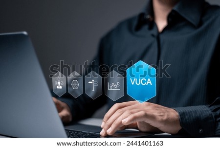 VUCA concept Volatility, Uncertainty, Complexity, Ambiguity. Strategic management, Rapid changes in business organizations. Businessman use laptop with VUCA icons on virtual screen.