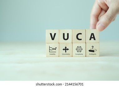 VUCA And Strategic Management. Wooden Cubes With VUCA Icon And Text; Volatility, Uncertainty, Complexity, Ambiguity With Grey Background. Smart Management For New Trend And Rapid Transition. 