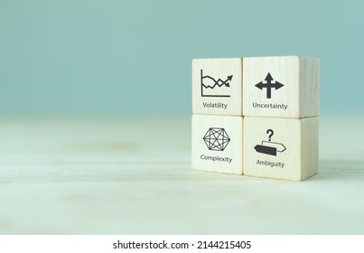 VUCA And Strategic Management. Wooden Cubes With VUCA Icon And Text; Volatility, Uncertainty, Complexity, Ambiguity With Grey Background. Smart Management For New Trend And Rapid Transition. 