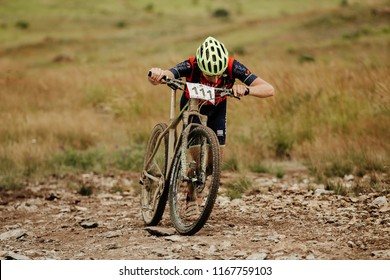 V.Ufaley, Russia - August 12, 2018: Athlete Cyclist Mountain Biker Uphill Walk During Race XCM Big Stone