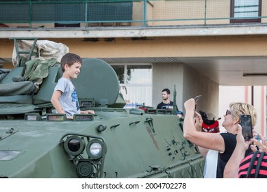 VUKOVAR, CROATIA - MAY 11, 2018: Kid, Boy, Young, Being Talekn In Photo By His Parents In An Armored Tank Of The Croatian Army. Also Called Hrvatska Vojska, Or Hv, It's The Armed Forces Of Croatia.

