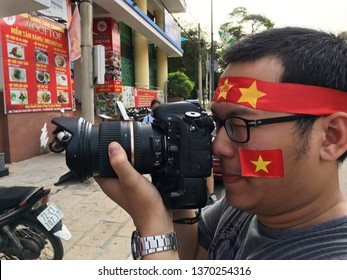 VUNG TAU, VIETNAM - JANUARY 27, 2018: A Vietnamese Fan Photographs Other Fans Watching The Final Of The 2018 AFC U 23 Championship. Uzbekistan Defeated Vietnam In The Final To Win Their First Title