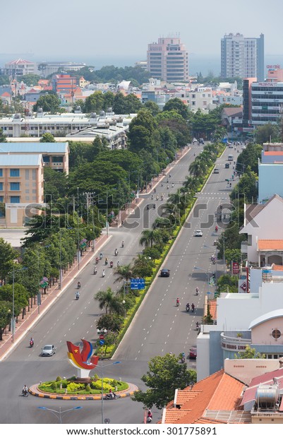VUNG TAU, VIETNAM - JUNE 29, 2015: Motorcyclists\
and vehicles move along a road in the downtown. Vung Tau is a\
maritime city in the southern\
Vietnam.