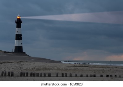 Vuurtoren Breskens lighthouse in the Netherlands shining in the night.