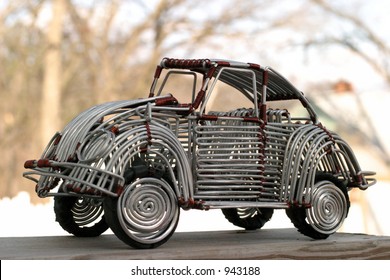 VW Beetle - toy handcrafted from wire, with opening doors and turning wheels. Made in Congo, Africa, in 2005.