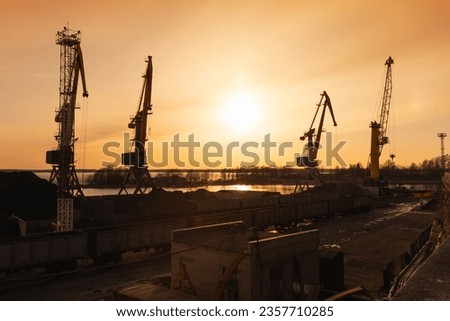 Vyborg coal terminal. Silhouettes of portal cranes in the evening