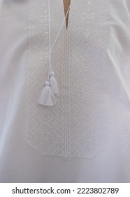 Vyshyvanka - Ukrainian National Dress. Men's Shirt, Embroidery With White Threads On White, Blur And Selective Focus. Cross Stitch, Geometric Ornament, Ukrainian Culture