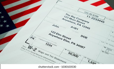 W2 Tax Form Copy A 2017 For Man Person John Doe Turns With American Usa Flag. Wage And Tax Statement