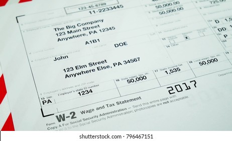 W2 Tax Form Copy A 2017 For Man Person John Doe Turns With American Usa Flag. Wage And Tax Statement