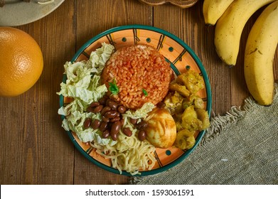 Waakye, Ghanaian cuisine, cooked rice and beans,  mixed with  boiled eggs, stewed meat. Traditional assorted African dishes, Top view.