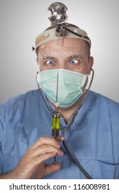 Wacky Doctor With A Syringe , Looking With Fear In Syringe Needle Tip