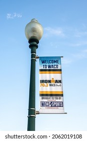 Waco, Texas - Oct. 21, 2021: Welcome to Waco banner on a lamppost  with a logo for the inaugural Ironman Waco event October 23 and 24.