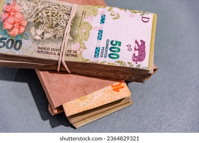 Wad of Argentine bills tied - Shutterstock ID 2364829321