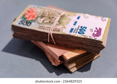 Wad of Argentine bills tied - Shutterstock ID 2364829325