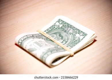 Wad of bills US banknotes folded  Cash of dollar bills with elastic band