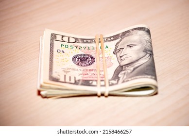 Wad of bills US banknotes folded  Cash of dollar bills with elastic band