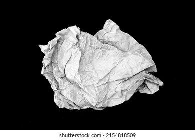wad of crumpled paper on black background
