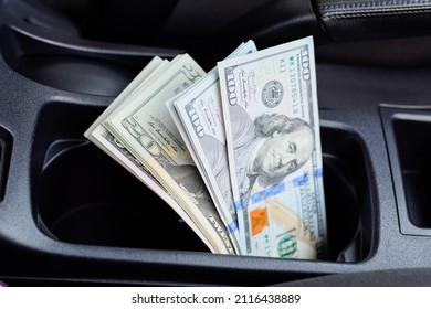 A wad of dollars inside the car. A wad of dollars inside the car. - Shutterstock ID 2116438889